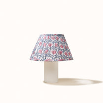 White pleated lampshade with a pink water lily print