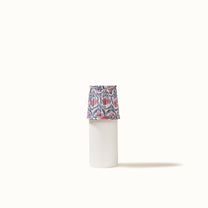 White pleated lampshade with a pink water lily print