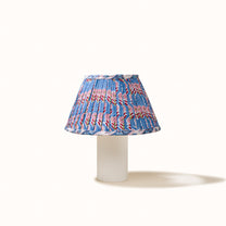 Blue pleated denim lampshade with a print of pink, red, and green flowers