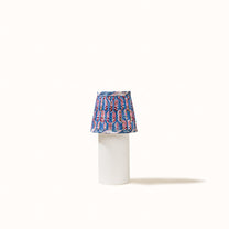 Blue pleated denim lampshade with a print of pink, red, and green flowers