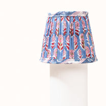 Blue pleated denim lampshade with a print of pink, red, and green flowers