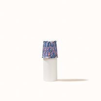 Blue pleated denim lampshade with a print of pink, red, and green flowers