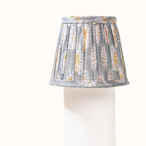 Green-gray pleated lampshade with saffron-yellow print