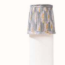 Green-gray pleated lampshade with saffron-yellow print
